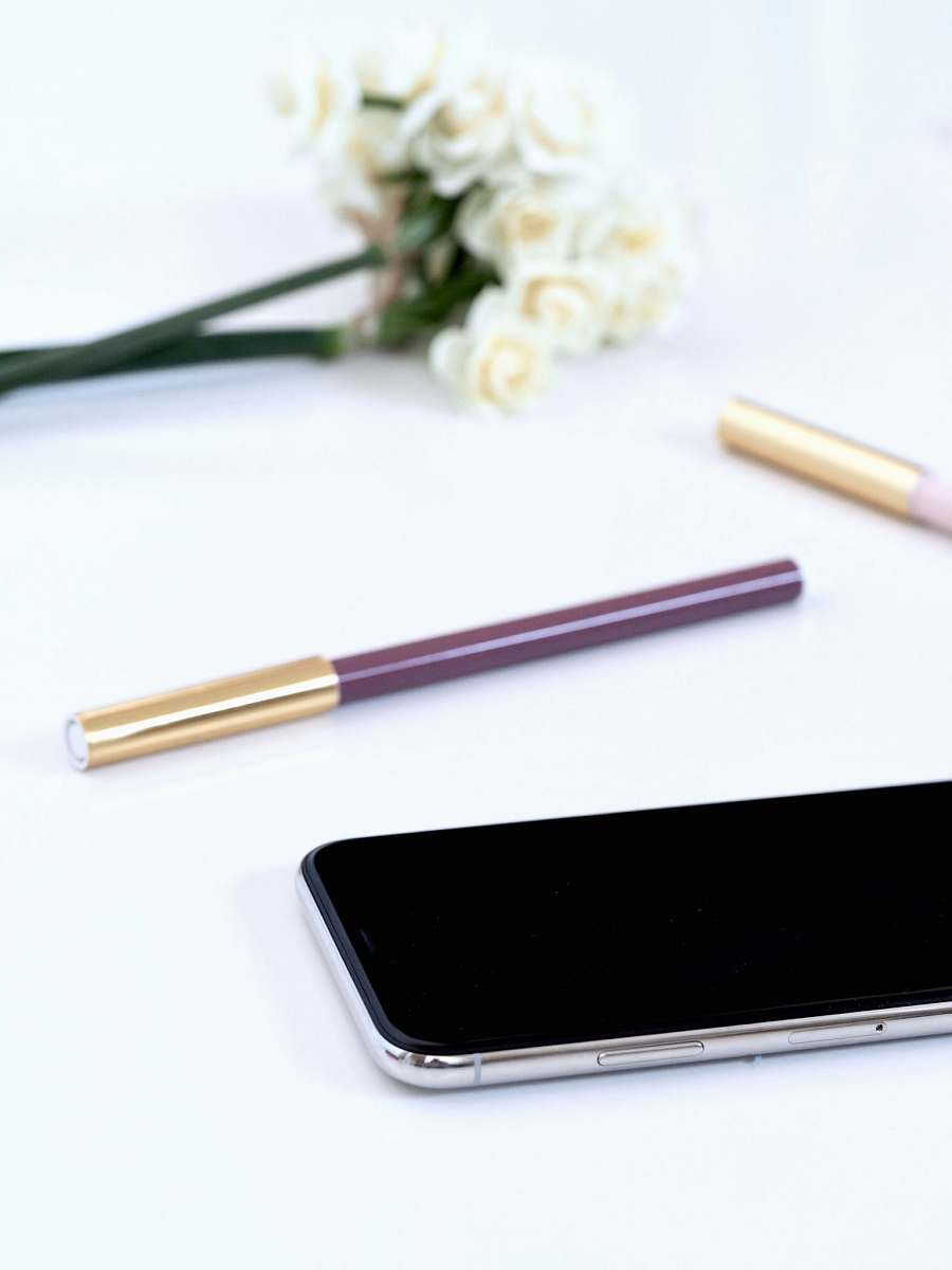 coffs harbour turned off black Android smartphone near brown pen on white surface australia